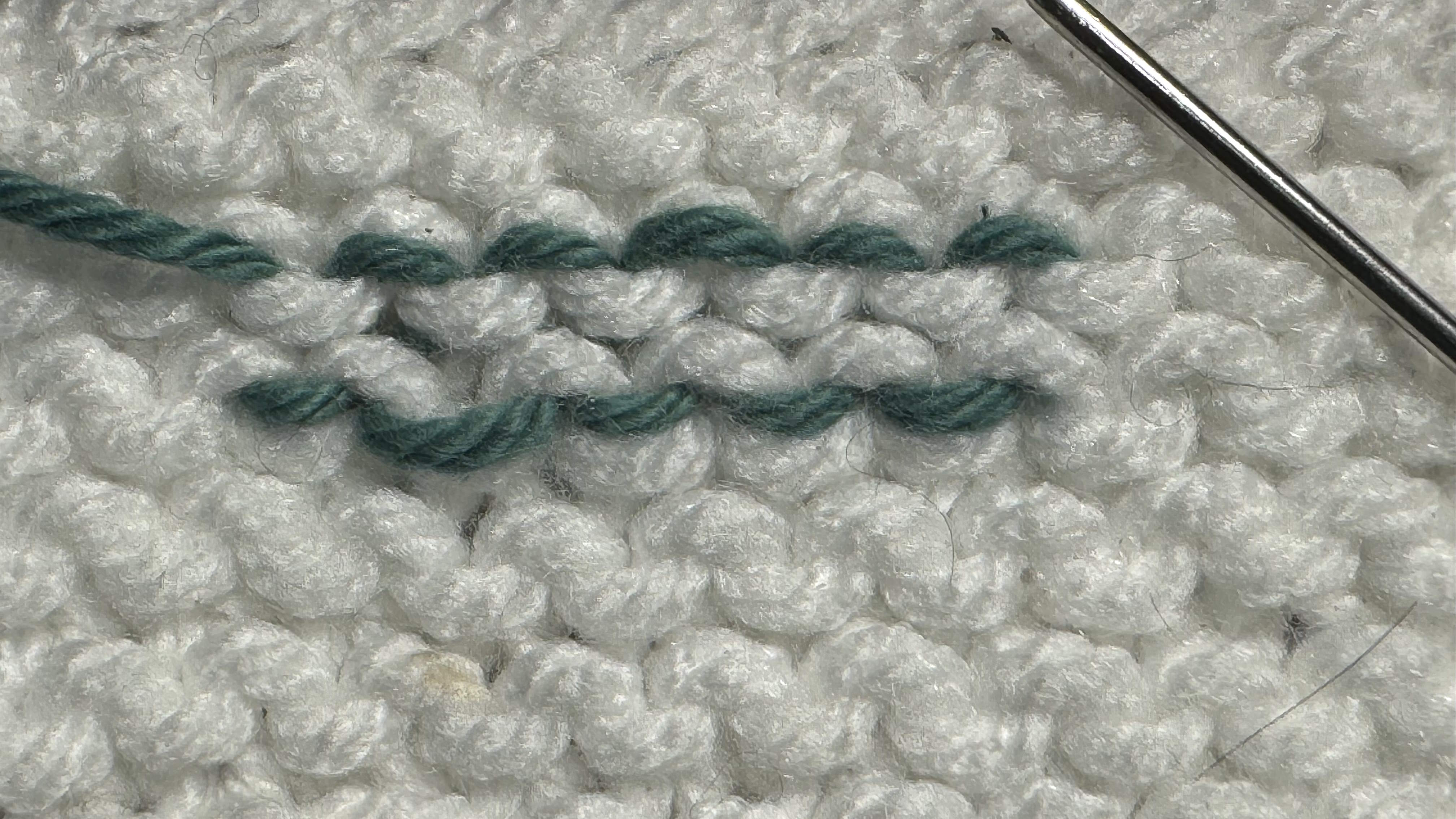 How to weave in ends in garter stitch pattern showing what it looks like on the wrong side