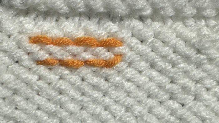 Weaving in ends in Stockinette Stitch using the duplicate stitch method, showing wrong side Weaving in ends in Stockinette Stitch using the duplicate stitch method, showing wrong side