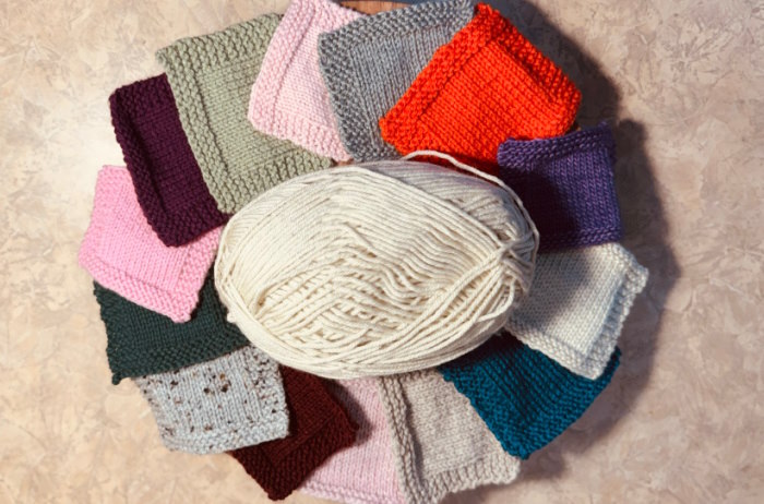 An assortment of knit stitches all worked in different worsted weight yarns