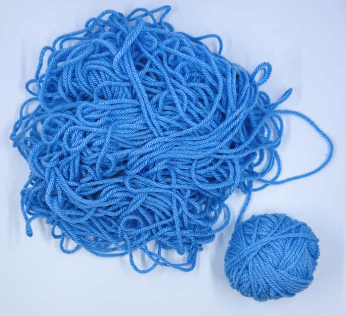 A pile of yarn called yarn barf in blue A pile of yarn called yarn barf in blue
