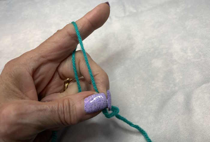 Very little tension is placed on the yarn when you hold the yarn in the palm of your hand and simply wrap it once around your index finger Very little tension is placed on the yarn when you hold the yarn in the palm of your hand and simply wrap it once around your index finger