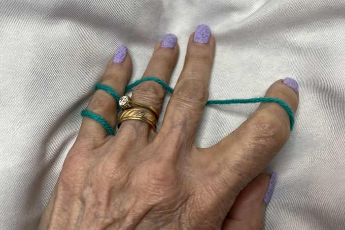 If you tend to crochet loosely, wrap the yarn around your small finger twice before weaving it between your other fingers. If you tend to crochet loosely, wrap the yarn around your small finger twice before weaving it between your other fingers.