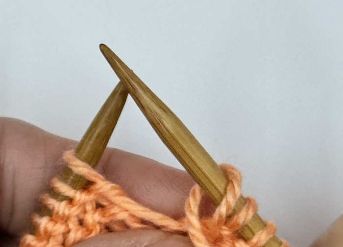 A yarnover between two purl stitches, step 2