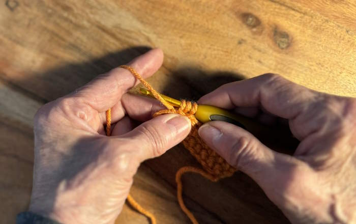 Demonstration of the yarn under in crochet